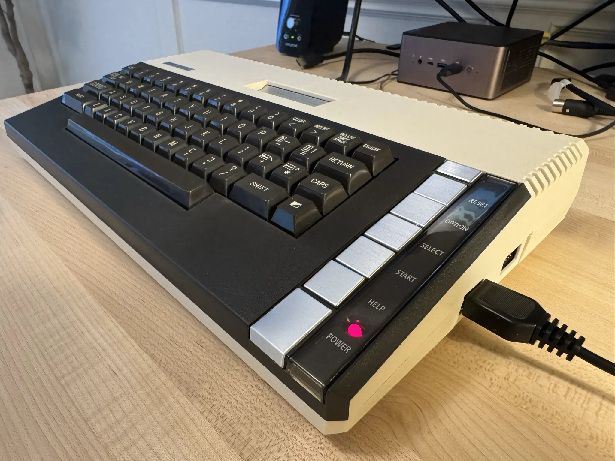 An original Atari 800XL computer with 5 console buttons, RESET, OPTION, SELECT, START and HELP displayed vertically on the right of the keyboard.