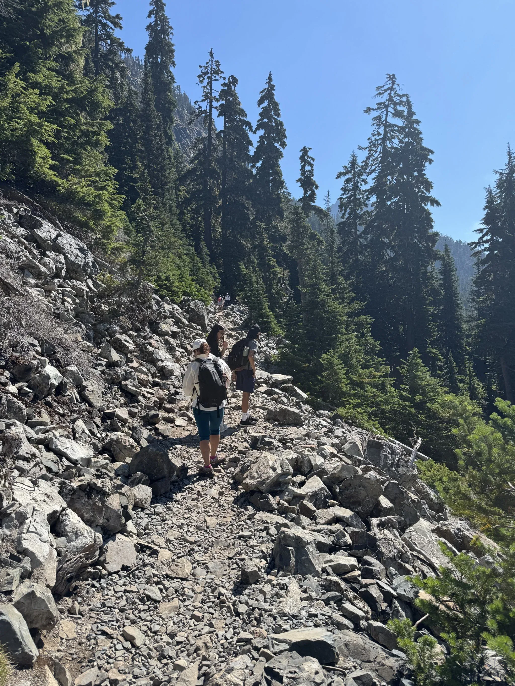 Hikers on a rocky switchback trail.